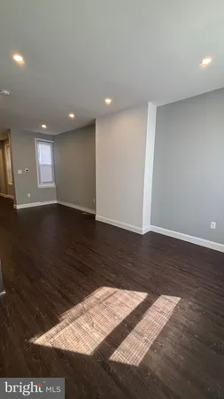 an empty room with wooden floor