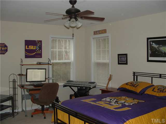 1908 Grace Point Road Morrisville, NC 27560 - Photo 14 of 22 Bedroom 4 upstairs; very spacious...ceiling fan and walk in closet. The pull down attic is in this room also. Bedroom