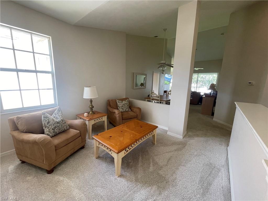317 Sunrise Cay, Unit 204 Naples, FL 34114 - Photo 12 of 19 a living room with furniture and a window