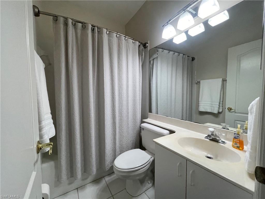 317 Sunrise Cay, Unit 204 Naples, FL 34114 - Photo 13 of 19 a bathroom with a sink toilet and shower