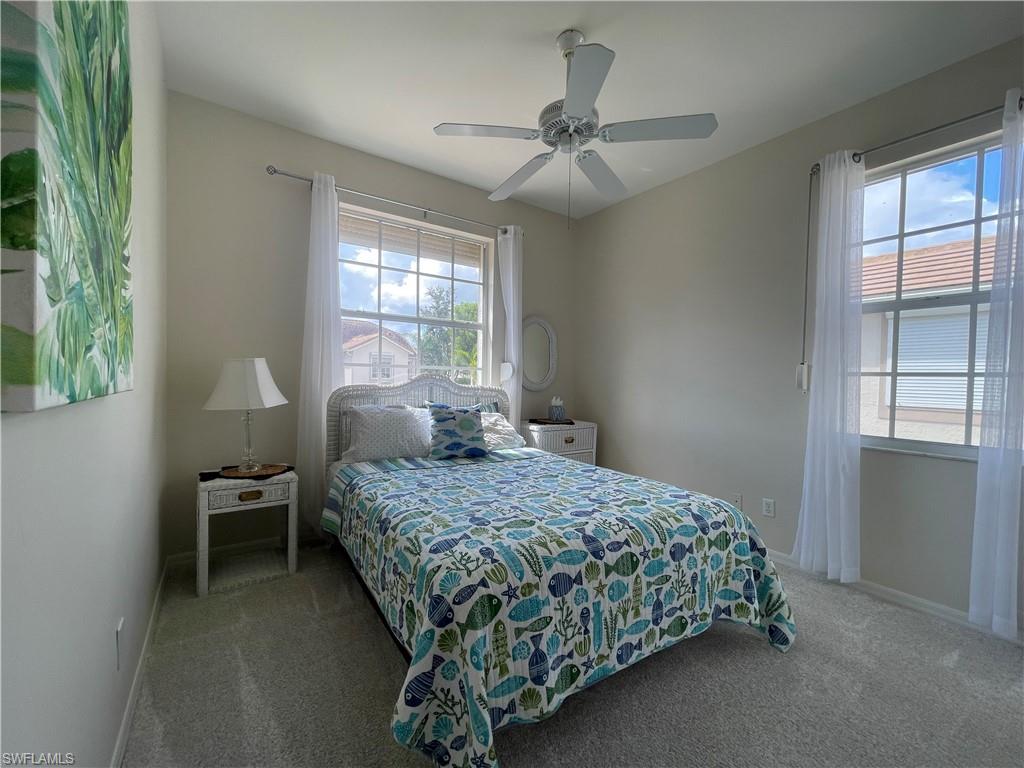 317 Sunrise Cay, Unit 204 Naples, FL 34114 - Photo 14 of 19 a bedroom with a bed and a window