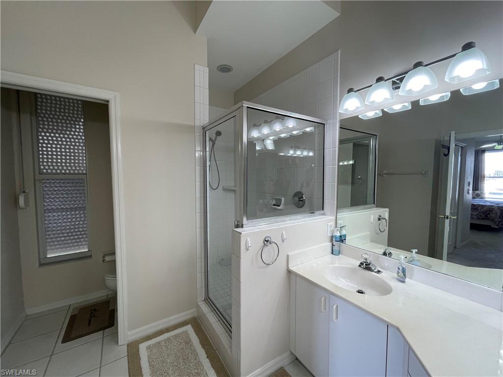 317 Sunrise Cay, Unit 204 Naples, FL 34114 - Photo 16 of 19 a bathroom with a sink vanity and mirror