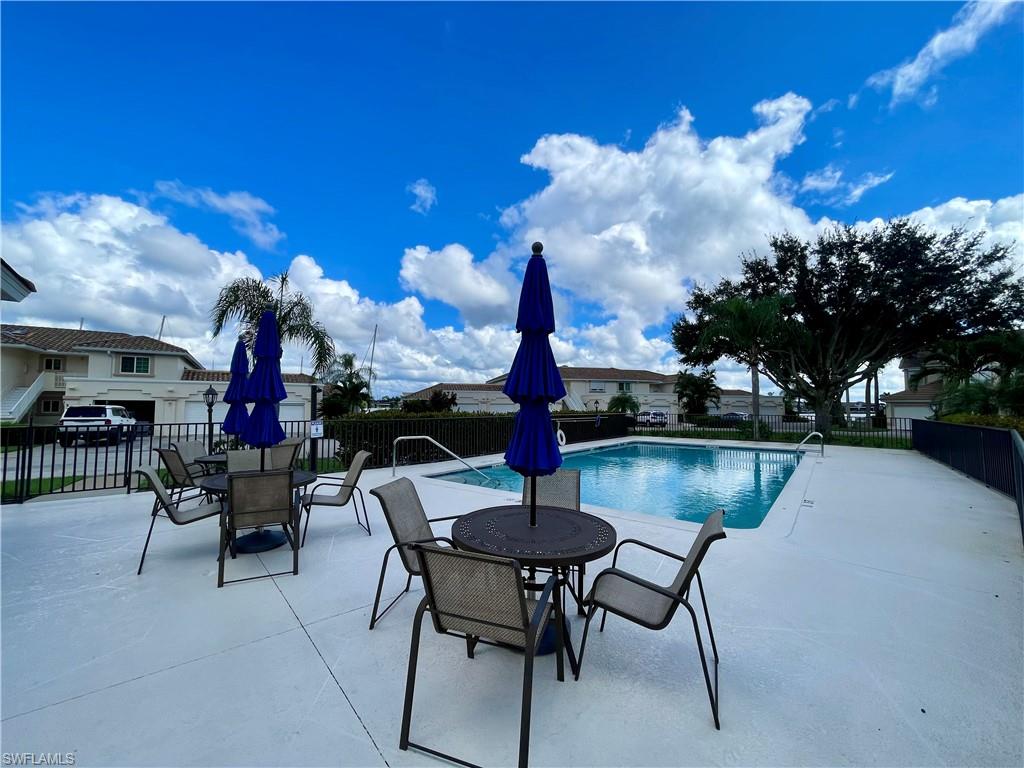 317 Sunrise Cay, Unit 204 Naples, FL 34114 - Photo 19 of 19 a swimming pool with outdoor seating and yard