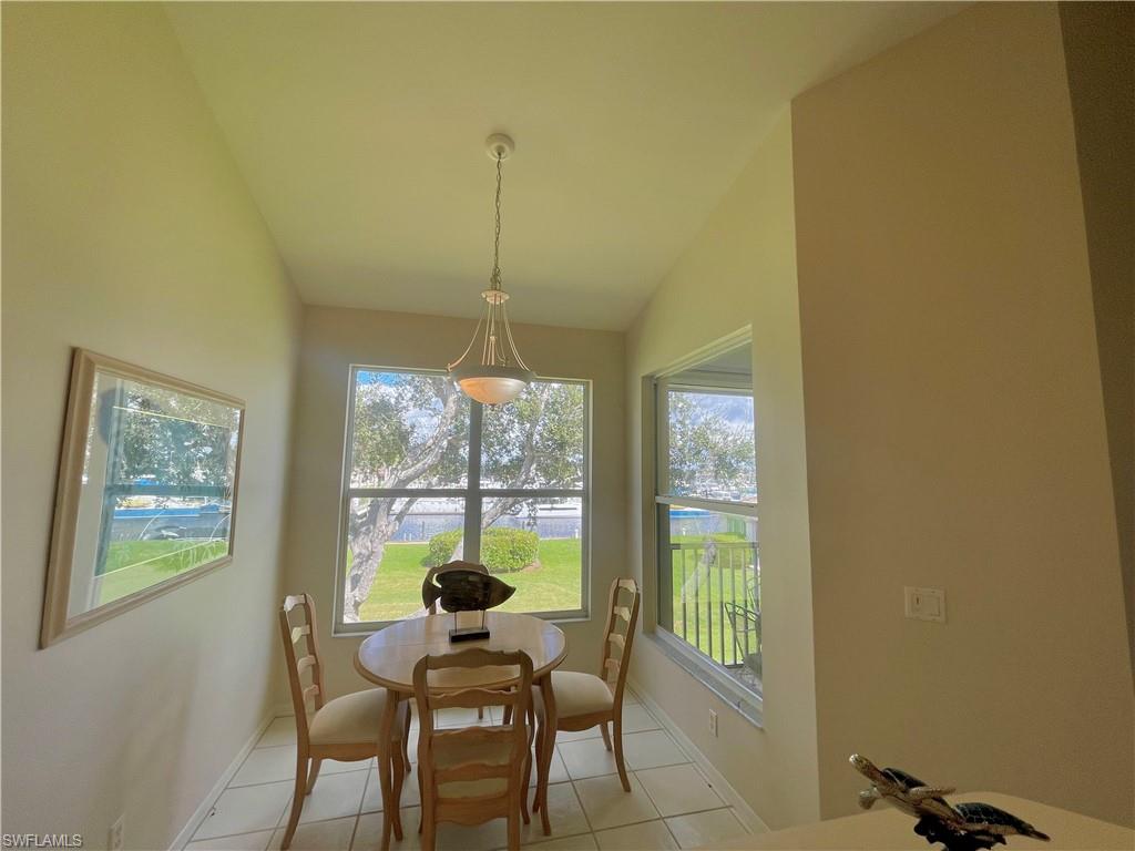 317 Sunrise Cay, Unit 204 Naples, FL 34114 - Photo 5 of 19 a dining room with furniture and window