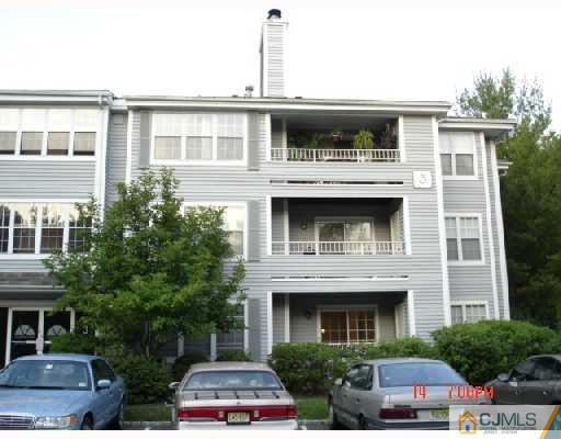 304 Raintree Court Helmetta, NJ 08828 - Photo 1 of 8 a white building with a window and balcony