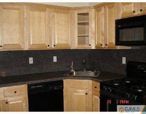 304 Raintree Court Helmetta, NJ 08828 - Photo 5 of 8 a kitchen with stainless steel appliances granite countertop a sink and a microwave