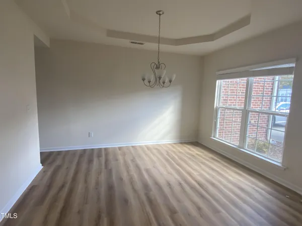 a view of an empty room with glass door and balcony