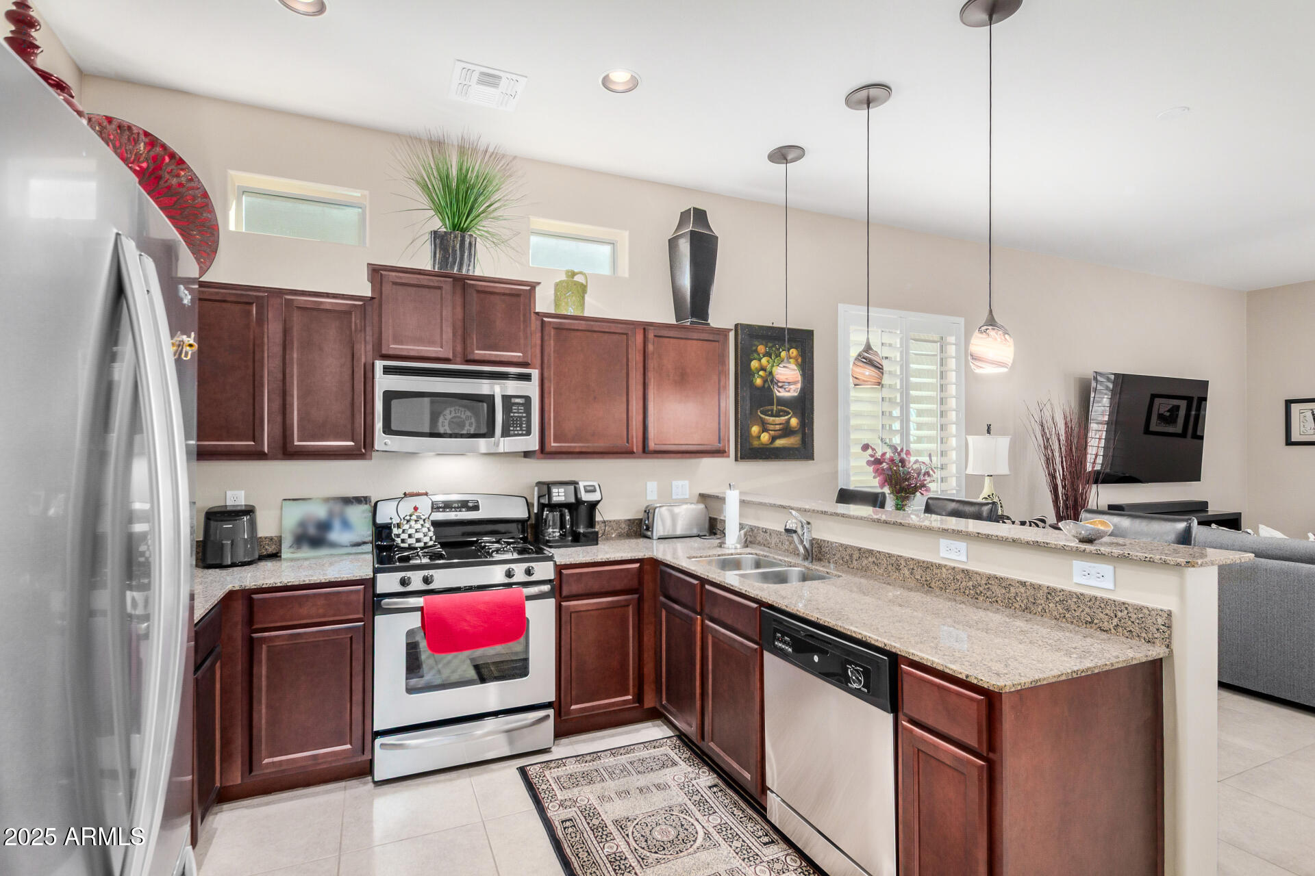 6202 East McKellips Road, Unit 139 Mesa, AZ 85215 - Photo 12 of 54 a kitchen with a sink a counter top space appliances and cabinets