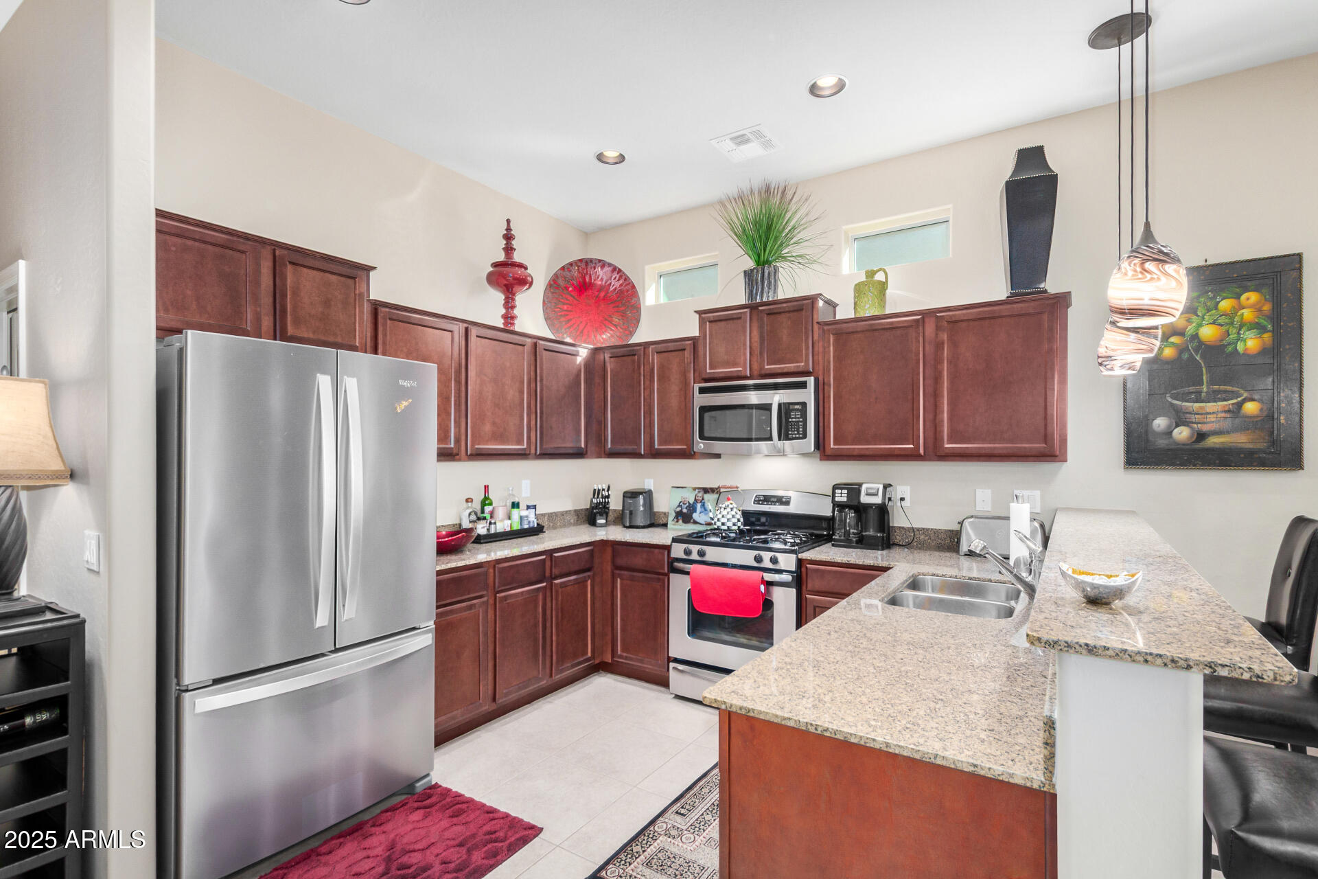6202 East McKellips Road, Unit 139 Mesa, AZ 85215 - Photo 13 of 54 a kitchen with stainless steel appliances granite countertop a refrigerator sink stove and microwave