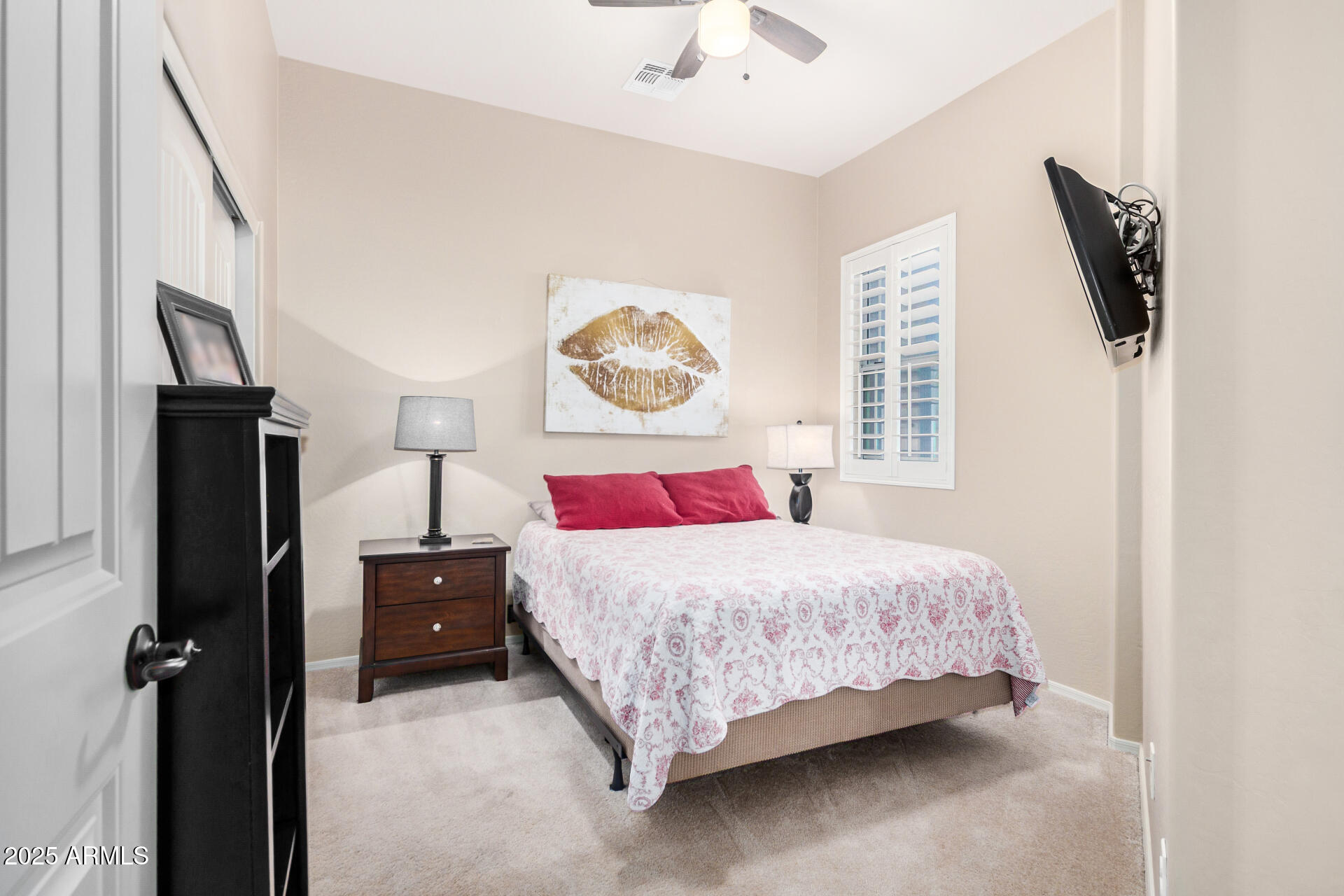 6202 East McKellips Road, Unit 139 Mesa, AZ 85215 - Photo 20 of 54 a bedroom with a bed and a painting on the wall