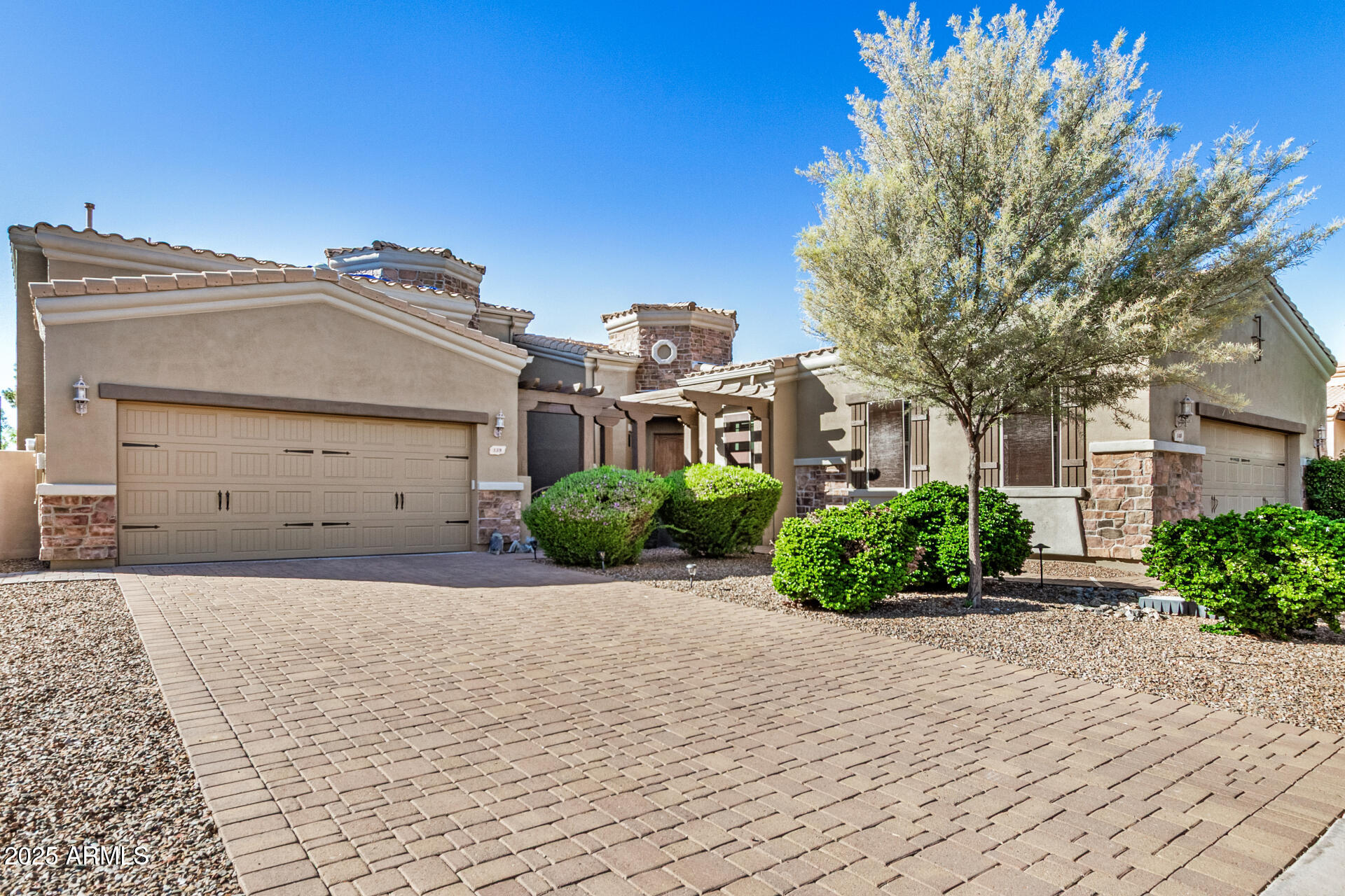 6202 East McKellips Road, Unit 139 Mesa, AZ 85215 - Photo 3 of 54 a front view of a house with a yard and garage