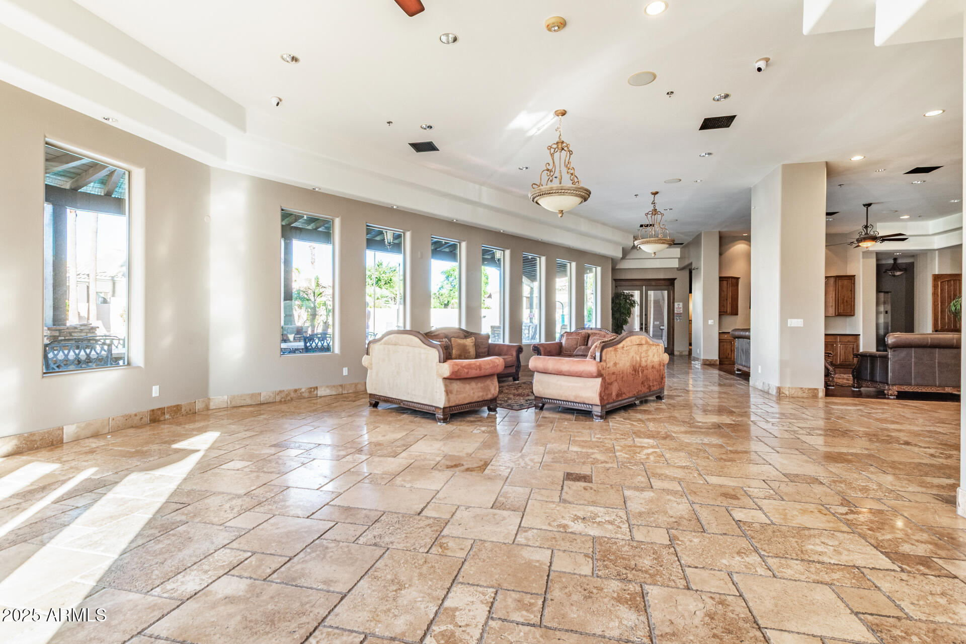 6202 East McKellips Road, Unit 139 Mesa, AZ 85215 - Photo 41 of 54 a spacious bedroom with a bed a chandelier and large window