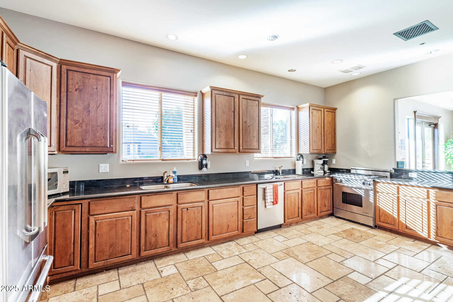 6202 East McKellips Road, Unit 139 Mesa, AZ 85215 - Photo 43 of 54 a large kitchen with stainless steel appliances granite countertop a stove sink and cabinets