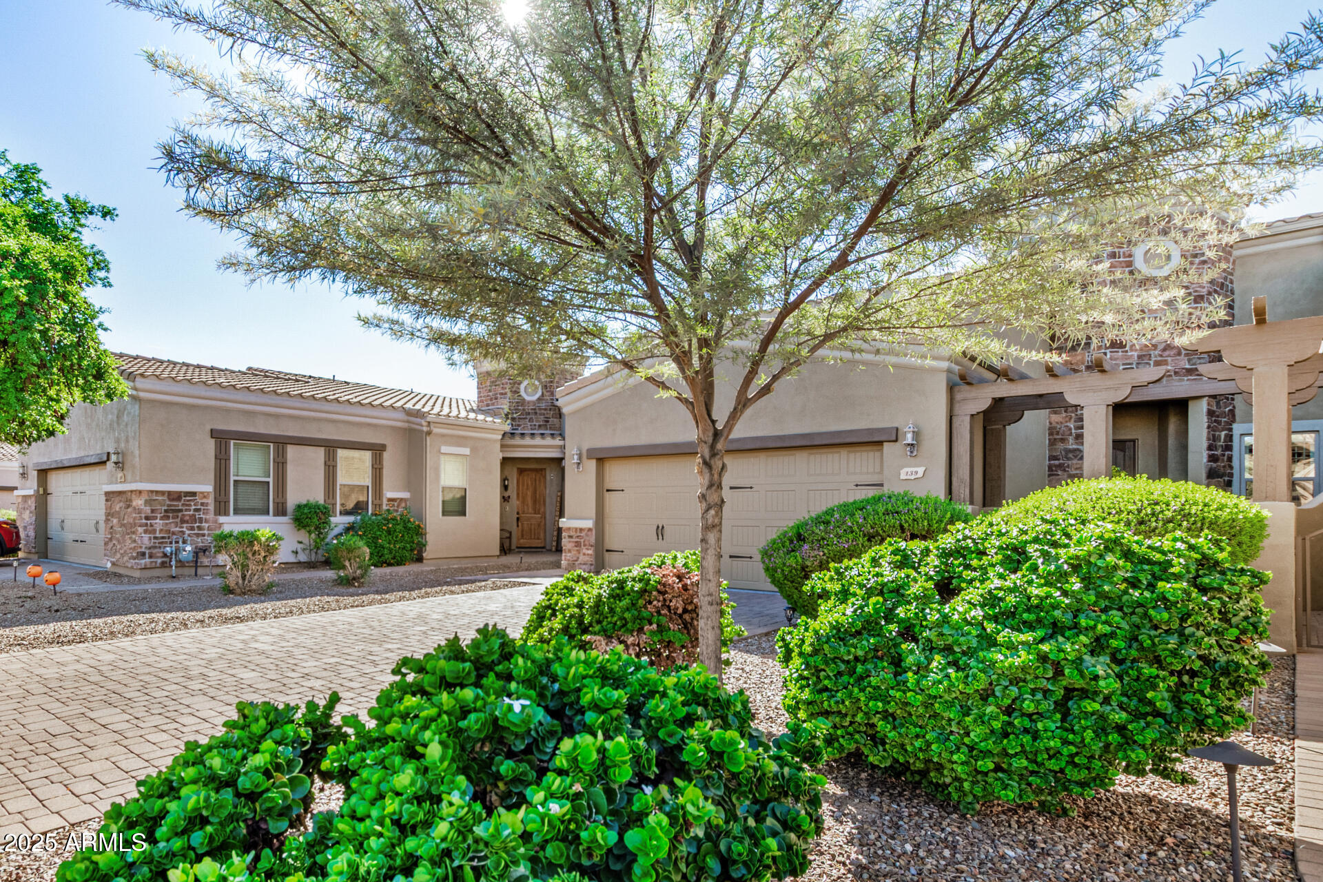 6202 East McKellips Road, Unit 139 Mesa, AZ 85215 - Photo 5 of 54 a front view of a house with a garden