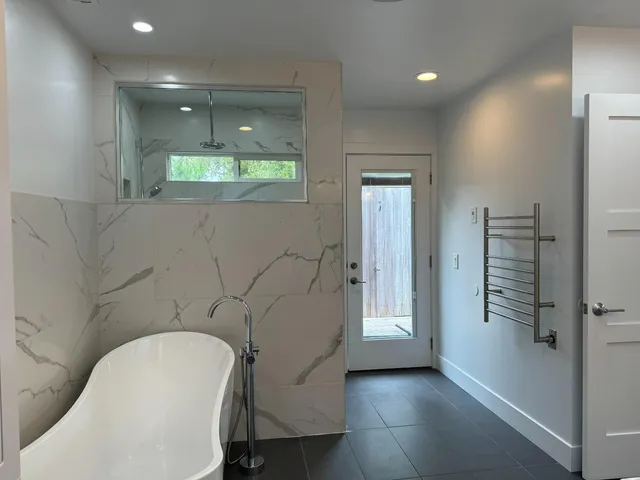 a bathroom with a bathtub and shower