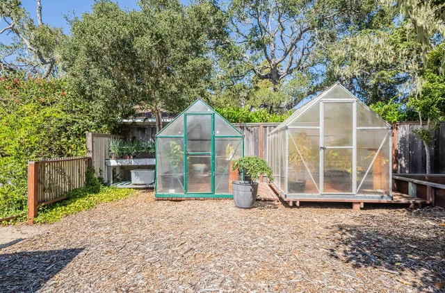 a view of a backyard with wooden fence