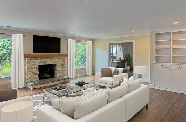 a living room with furniture windows and a fireplace