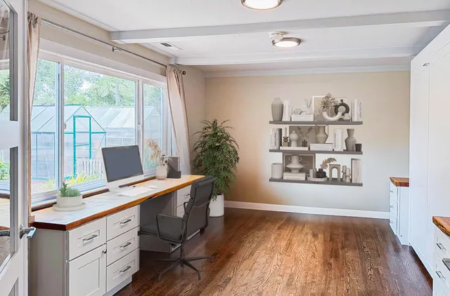 a view of workspace with wooden floor and a window