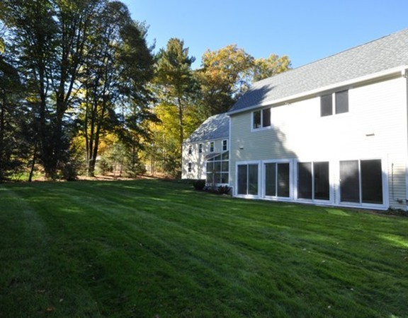 13 Garland Road Concord, MA 01742 - Photo 3 of 28 a large building with a big yard and large trees