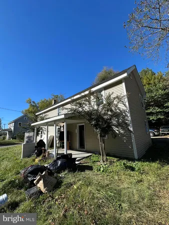 a view of a house with backyard sitting area and garden