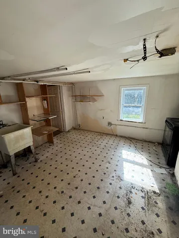 a bedroom with a bed and a refrigerator