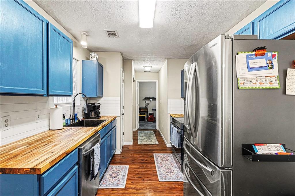 30 Pheasant Court Monticello, GA 31064 - Photo 12 of 30 a kitchen with stainless steel appliances granite countertop a refrigerator and a sink
