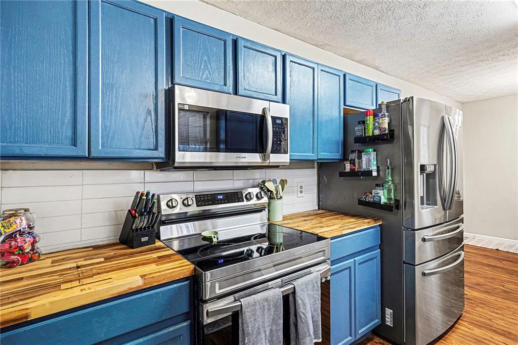 30 Pheasant Court Monticello, GA 31064 - Photo 14 of 30 a kitchen with stainless steel appliances granite countertop a refrigerator stove and microwave