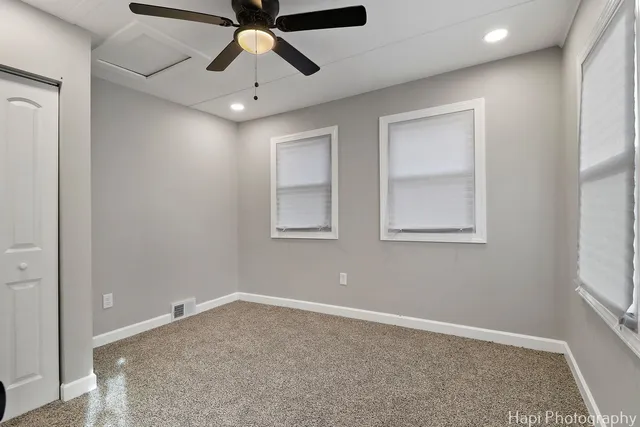 a view of a livingroom with a ceiling fan and window