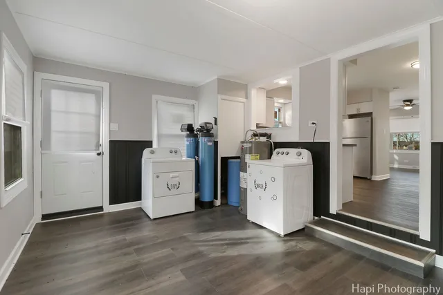 a utility room with cabinets washer and dryer