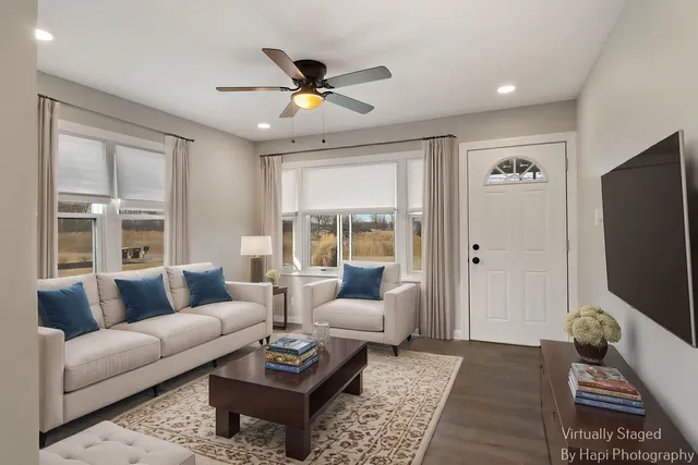 a living room with furniture and a flat screen tv
