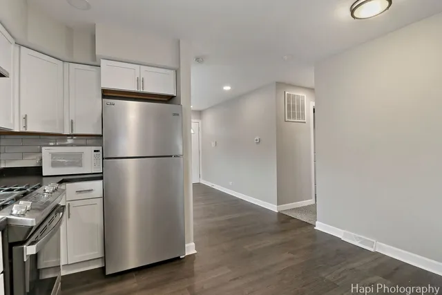 a kitchen with wooden cabinets and white stainless steel appliances