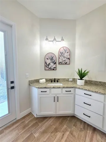 a bathroom with a granite countertop sink and a stove