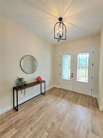 a view of a room with wooden floor and windows