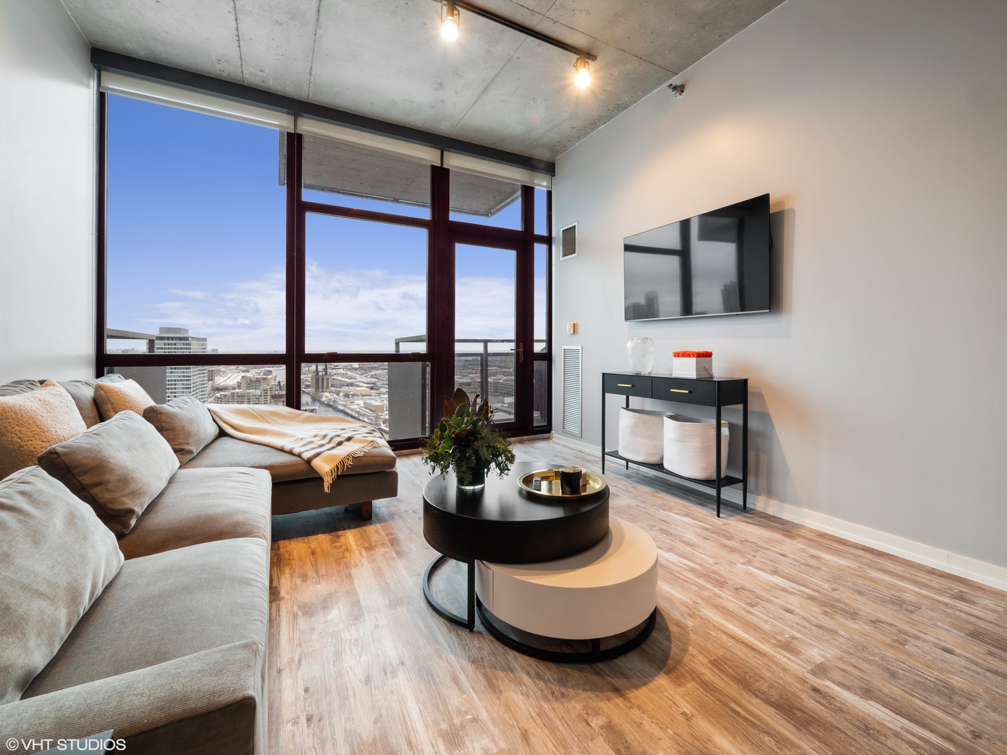 235 West Van Buren Street, Unit 2811 Chicago, IL 60607 - Photo 3 of 10 a living room with furniture and a flat screen tv