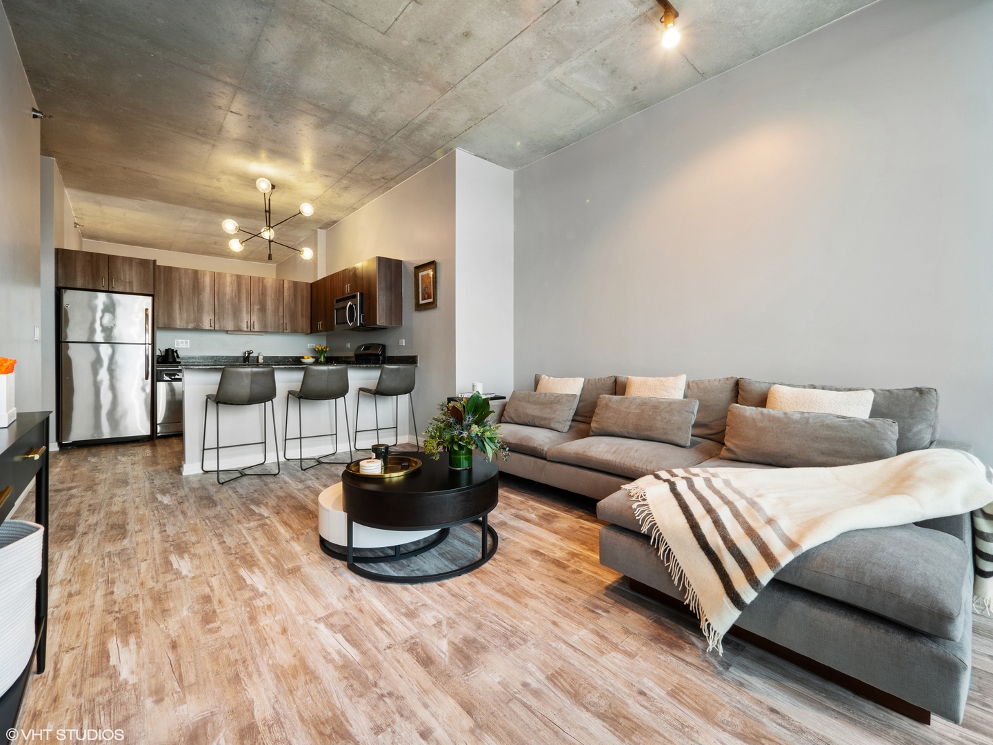 235 West Van Buren Street, Unit 2811 Chicago, IL 60607 - Photo 4 of 10 a living room with furniture and a flat screen tv