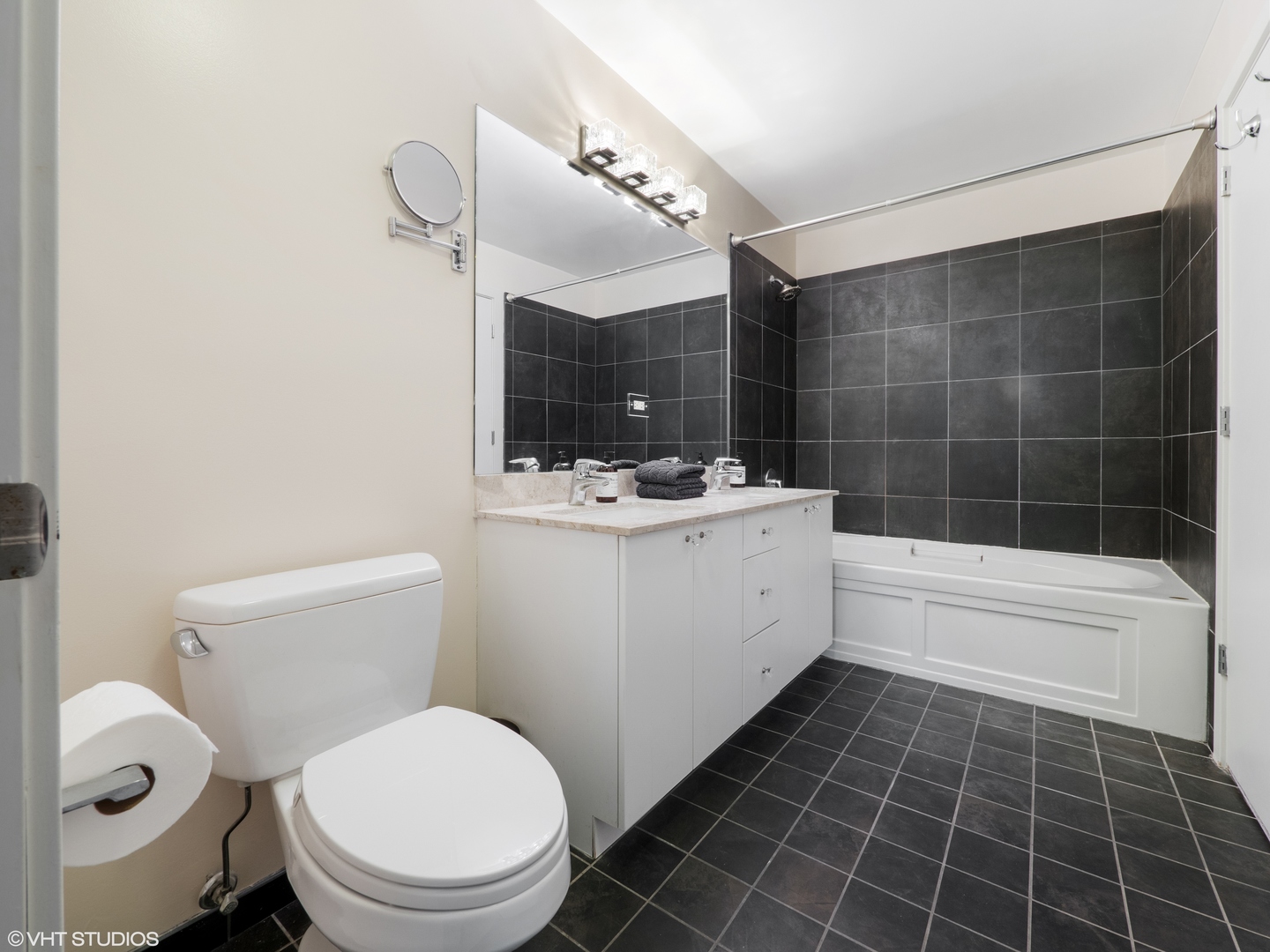 235 West Van Buren Street, Unit 2811 Chicago, IL 60607 - Photo 7 of 10 a bathroom with a sink a toilet and shower