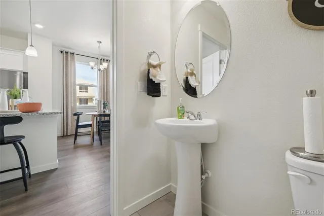 a bathroom with a sink mirror and toilet