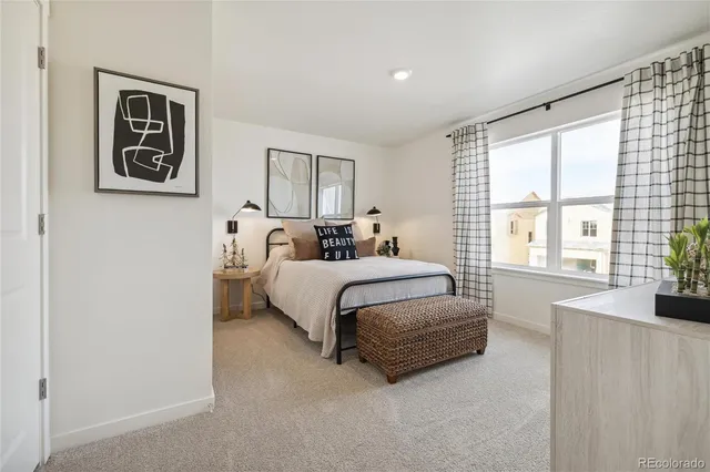 a bedroom with bed and a large window