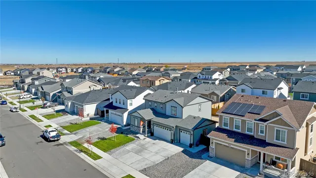 an aerial view of multiple houses with a yard