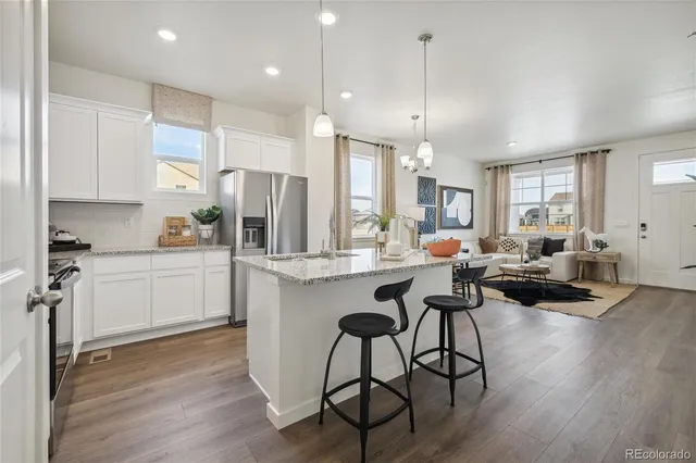 a kitchen with counter space appliances and a dining table