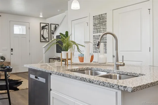a bathroom with a granite countertop sink a mirror and vanity