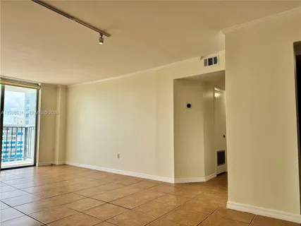 a view of an empty room and a fan