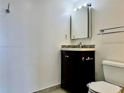 an empty room with windows and a ceiling fan