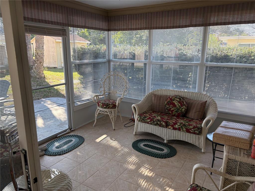 5338 Spanish Trail Holiday, FL 34690 - Photo 11 of 34 a living room with furniture and a floor to ceiling window