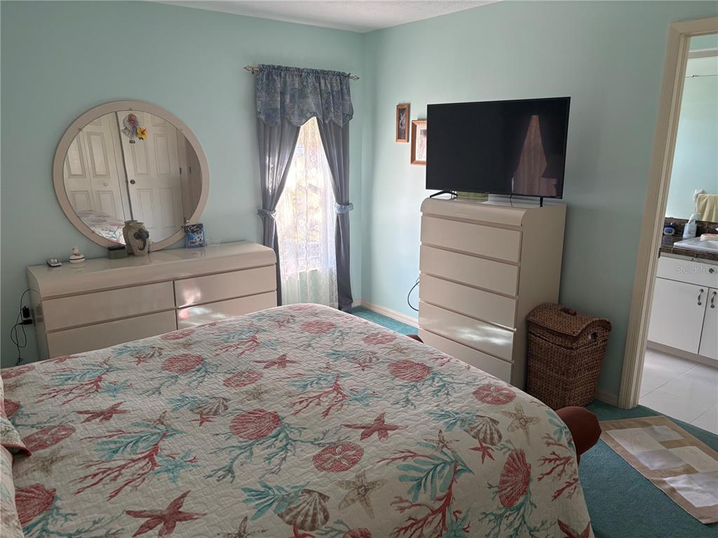 5338 Spanish Trail Holiday, FL 34690 - Photo 15 of 34 a bedroom with a bed and a television