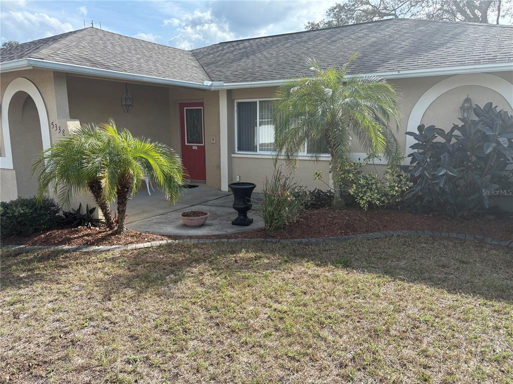 5338 Spanish Trail Holiday, FL 34690 - Photo 2 of 34 a front view of a house with garden