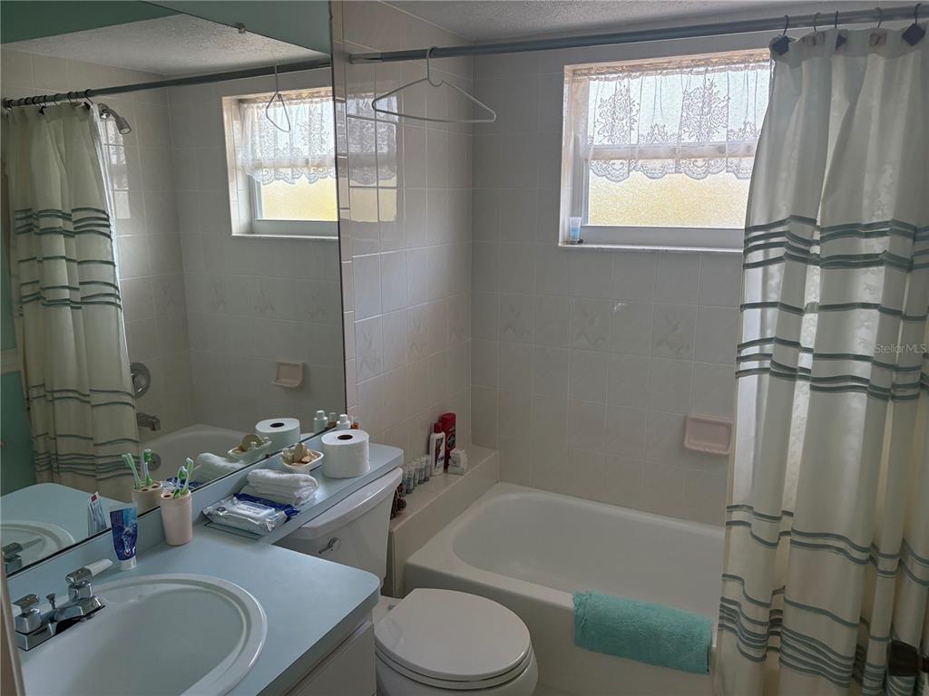 5338 Spanish Trail Holiday, FL 34690 - Photo 22 of 34 a bathroom with a sink toilet and shower