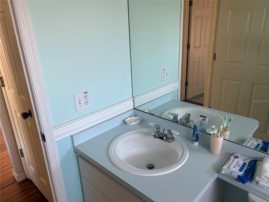 5338 Spanish Trail Holiday, FL 34690 - Photo 23 of 34 a bathroom with a sink and a mirror