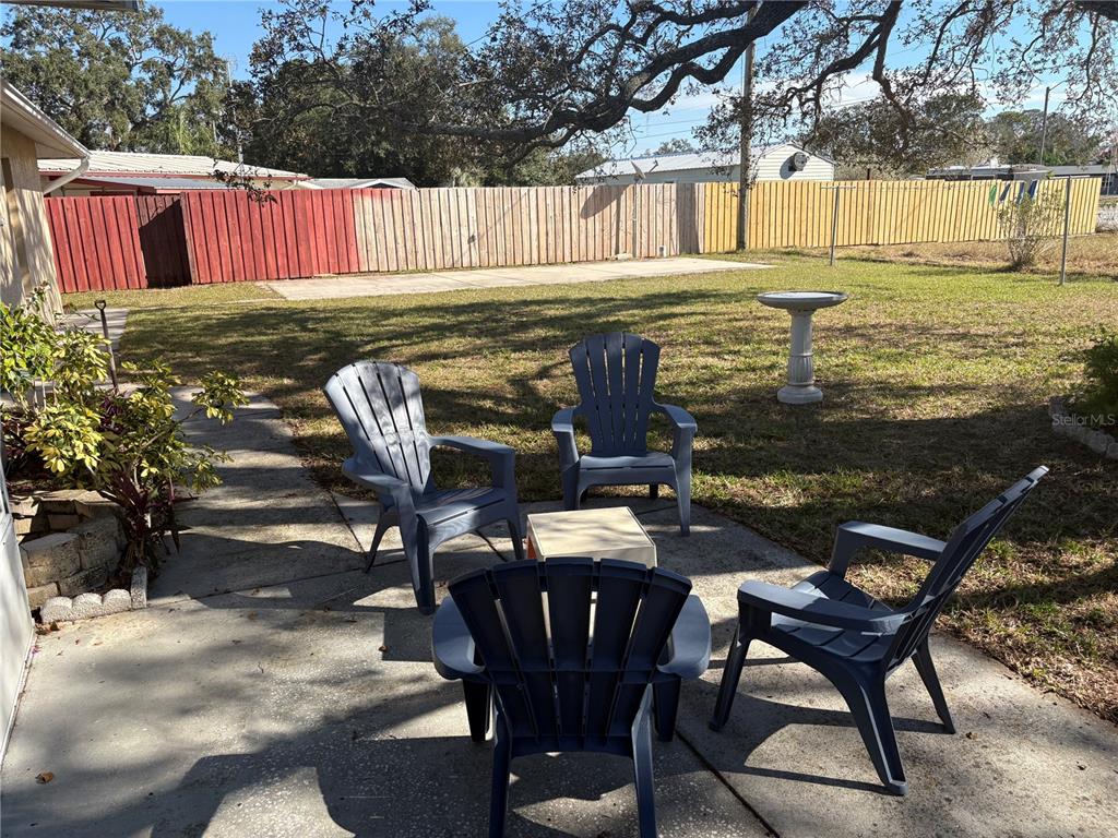 5338 Spanish Trail Holiday, FL 34690 - Photo 24 of 34 a view of a swimming pool with a table and chairs
