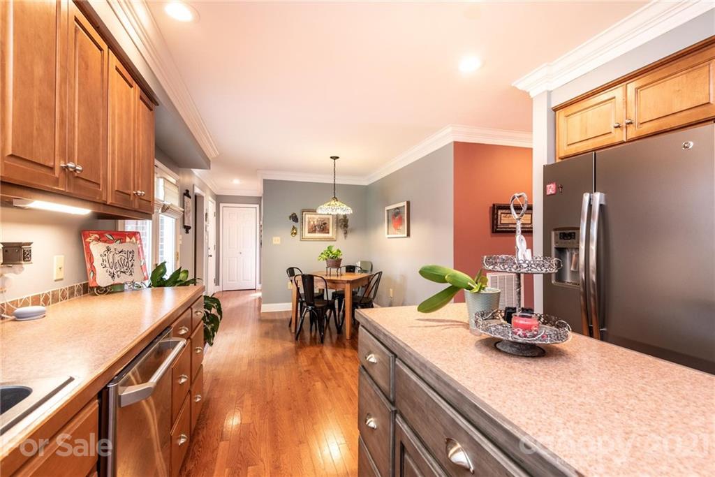 4542 Hickory Nut Ridge Road Granite Falls, NC 28630 - Photo 14 of 38 a kitchen with stainless steel appliances dining table and chairs